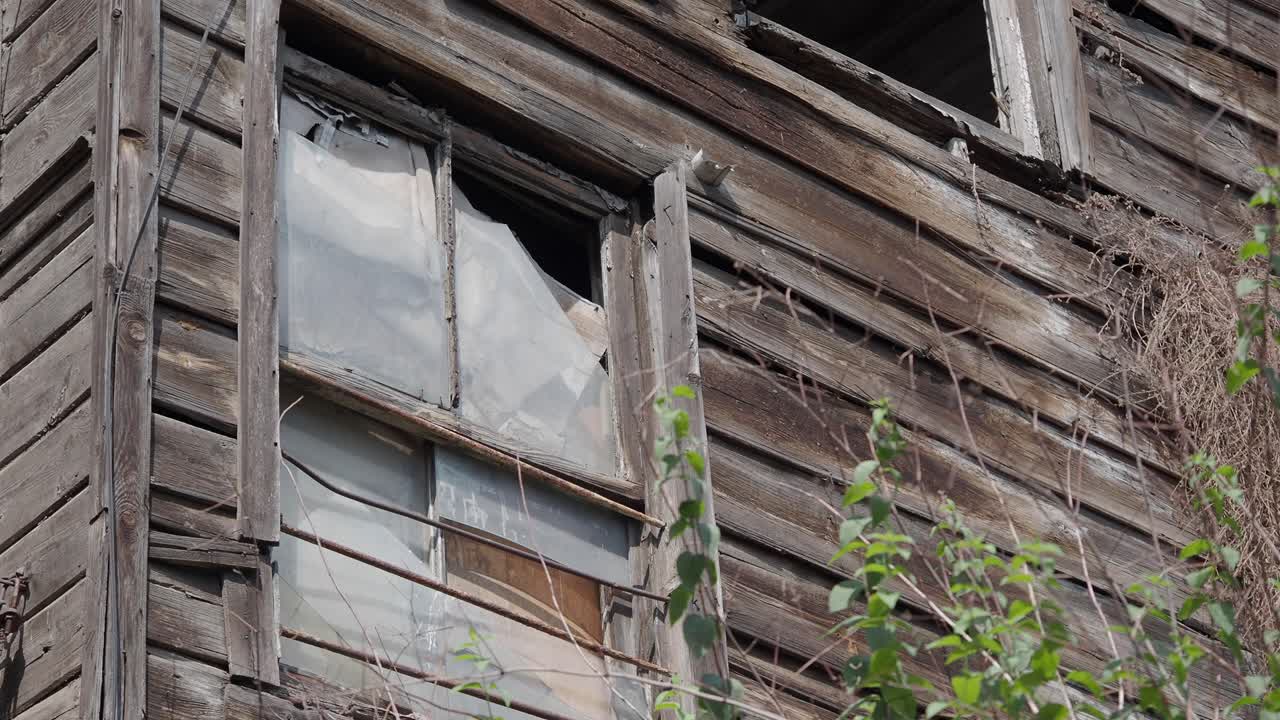 Dilapidated Wooden House with Broken Windows