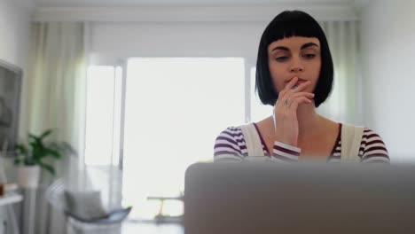 Woman-using-laptop-at-home-4k