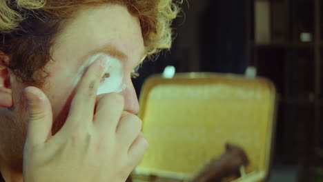 clown doing makeup and making faces in dressing room