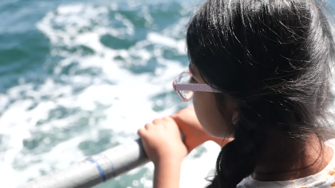 Child looking at the ocean from a boat