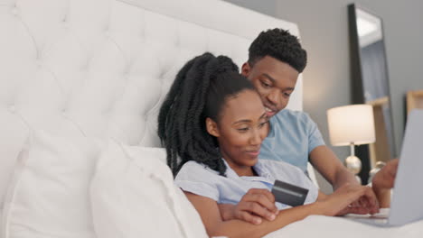 Bed,-credit-card-and-couple-online-shopping