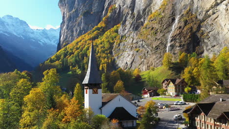 rotating drone shot of the staubbach waterfall church in lauterbrunnen bernese oberland switzerland