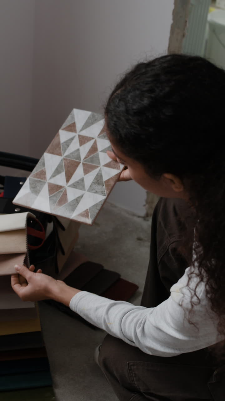 Interior Designer Selecting Tiles and Fabrics for Home Renovation