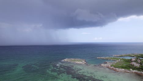 rain in the caribbean sea next to an abandoned hotel drone shoot tracking sideways