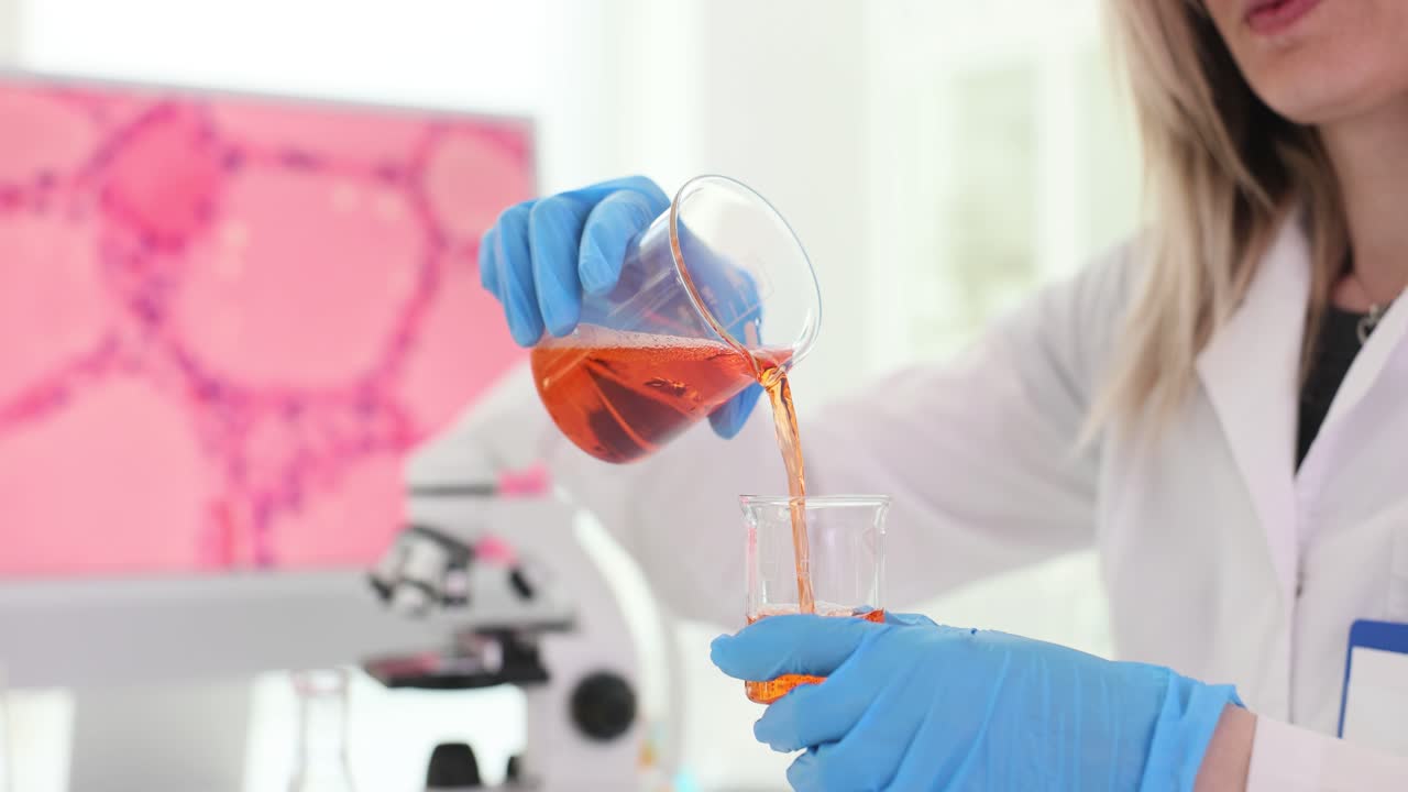 Scientist pouring liquid in a lab