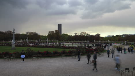 tourists at jardin du luxembourg park- luxembourg gardens, day time overcast, clouds moving time lapse.