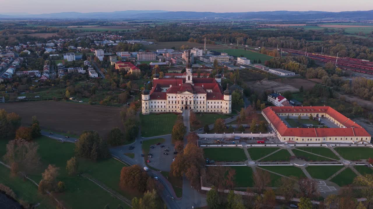 Military Hospital at Klášterní Hradisko in Olomouc captured from a drone during autumn showing the historic architecture surrounded by colorful trees and peaceful city scenery