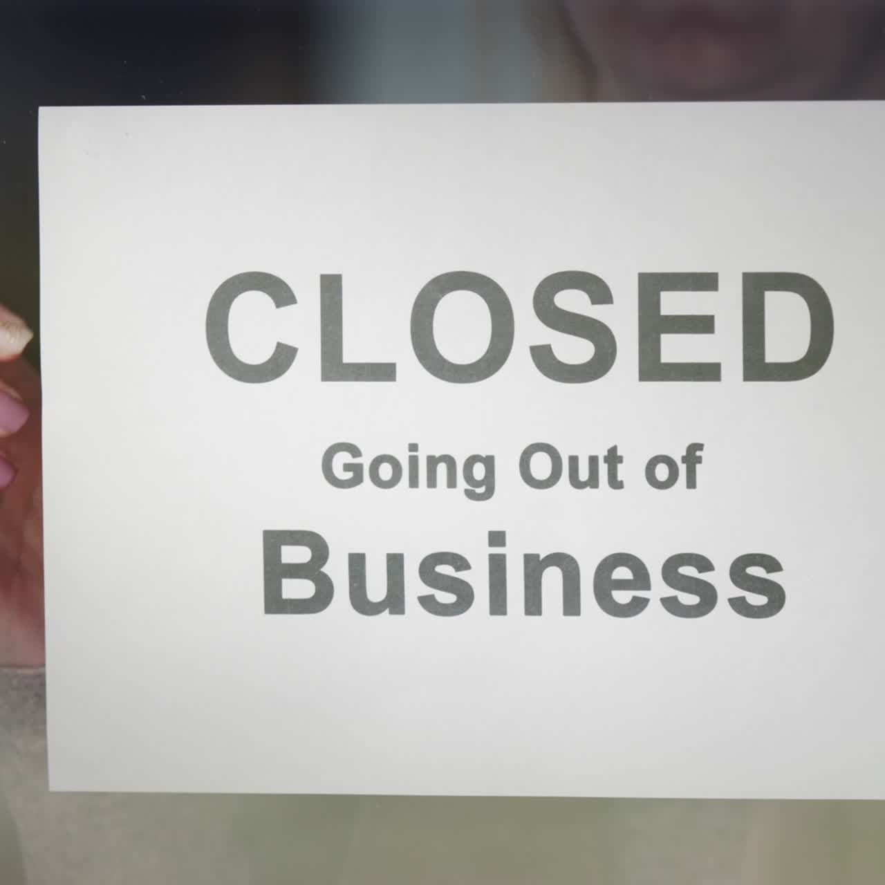 Worker Hangs A Banner Stating Closed Going Out Of Business On The Door
