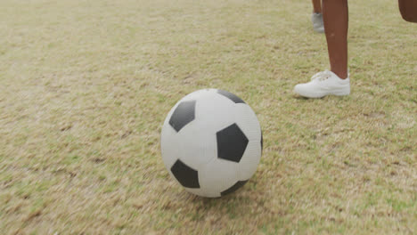 Video-of-legs-of-diverse-girls-playing-soccer-in-front-of-school