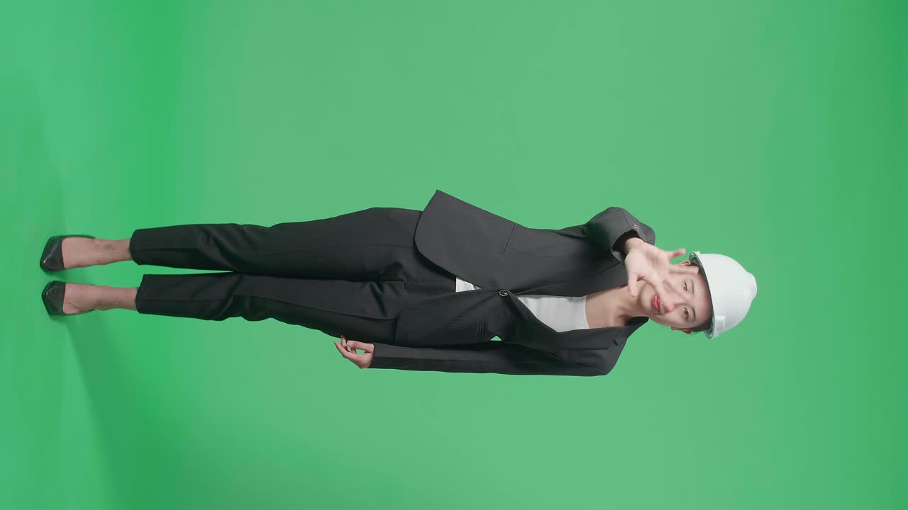 Full Body Of Upset Asian Female Engineer Showing Gesture Hands Palm And Waving While Shaking Head In The Green Screen Studio
