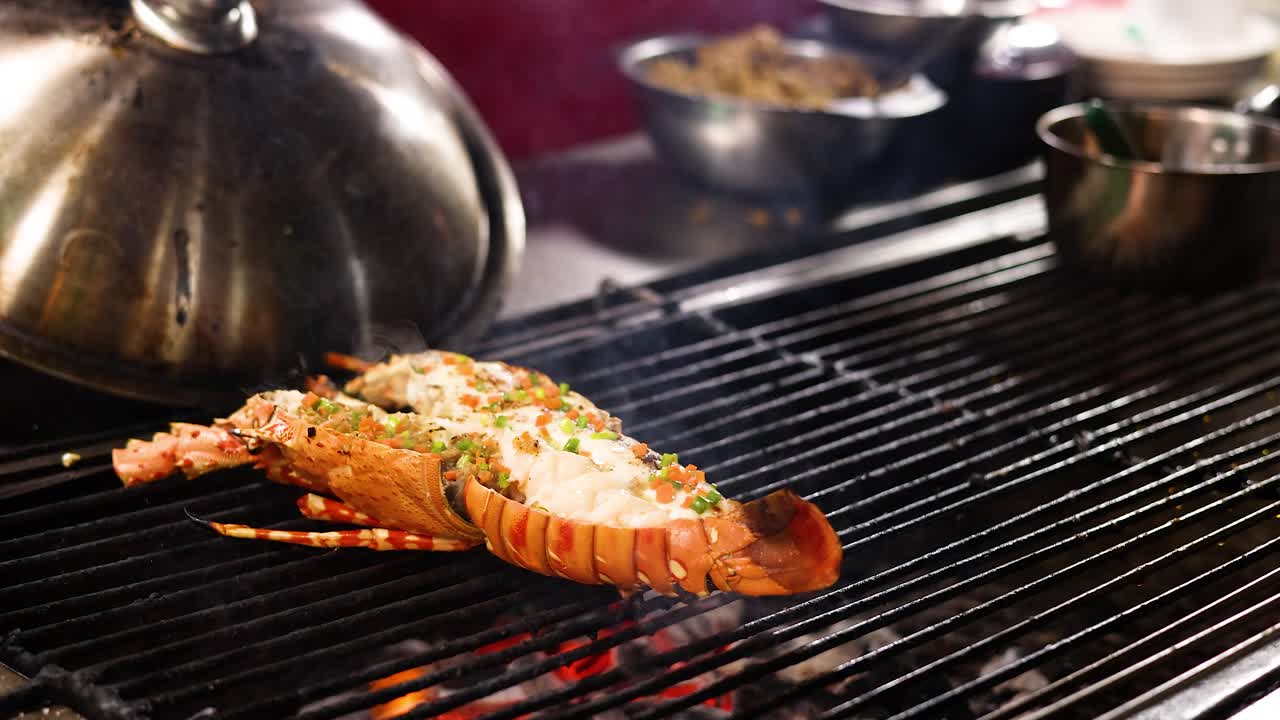 Chef adds herbs to lobster on open grill, vibrant street food setting, warm lighting, close-up