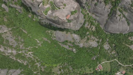 Epic-drone-top-down-view-of-Holy-Trinity-monastery-in-Meteora-atop-rock-monolith