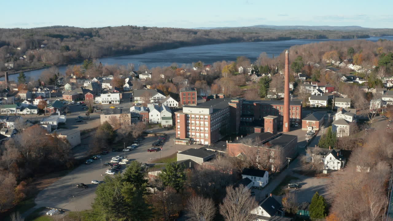 Aerial view of rural Winthrop Maine, a factory town with a textile mill and Maranacook lake in the background
