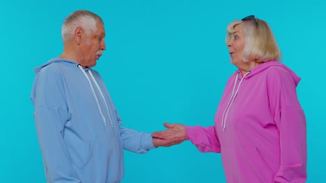 grandmother grandfather showing thumbs up, pointing empty place advertising area for commercial text