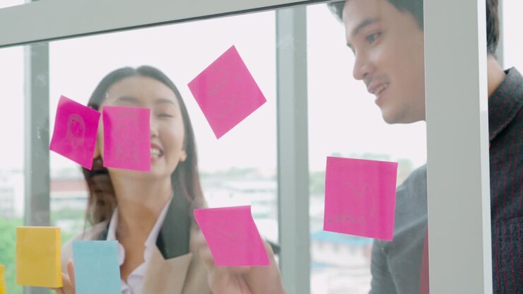 Business people work on project planning board