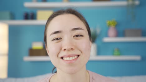 Close-up-portrait-of-satisfied-Asian-young-woman.