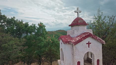 small chapel on a hilltop overlooking the mountains