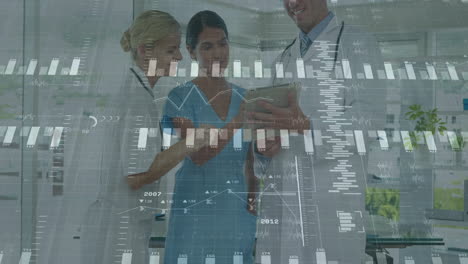 medical team reviewing tablet data in medical office, showing animated health charts and graphs