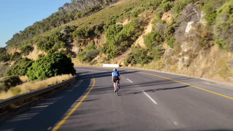 Healthy-man-cycling-road-bicycle-outdoors-fitness-steadicam-shot