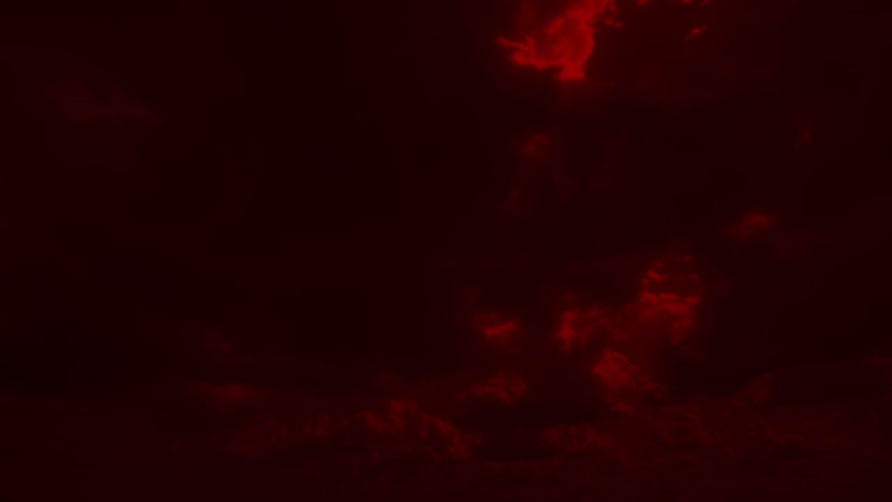 Red stormy clouds move rapidly across sky. Dramatic and moody background for horror, sci-fi, or mars environment concepts