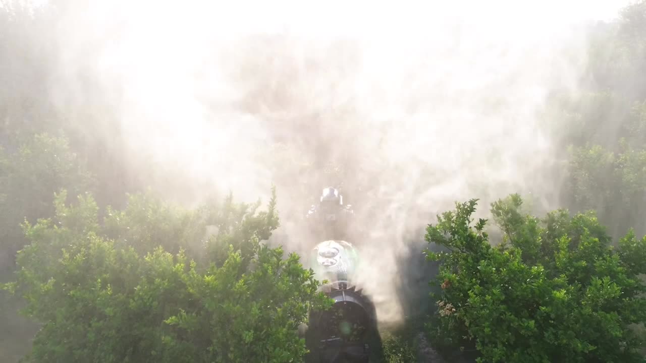 Tractor spraying pesticide drone aerial view, pesticides or insecticide spray on lettuce or iceberg field. Pesticides and insecticides on agricultural field in Spain