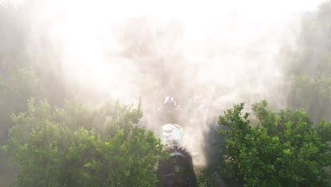 tractor spraying pesticide drone aerial view, pesticides or insecticide spray on lettuce or iceberg field. pesticides and insecticides on agricultural field in spain