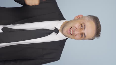 vertical video of businessman showing his mind looking at camera.