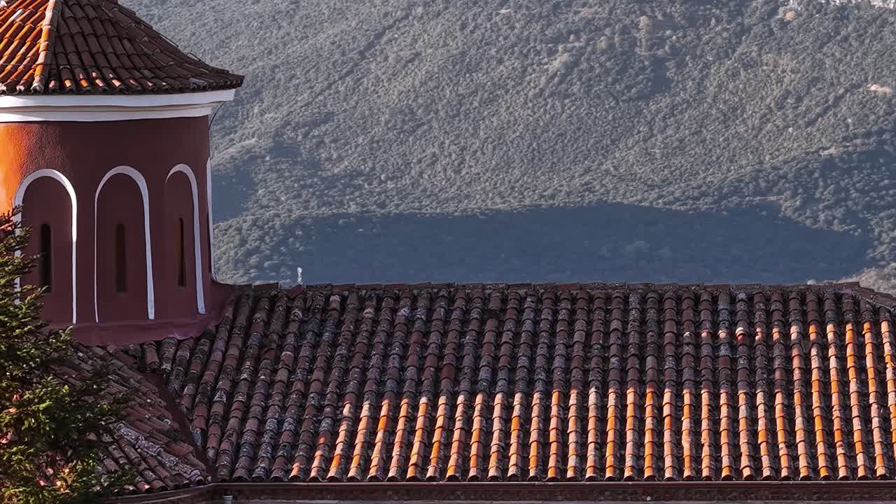 Architettura storica sui tetti in Grecia con sfondo montuoso