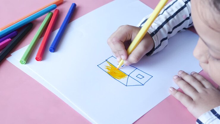 Girl Drawing a House with Markers