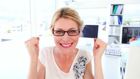 Excited-businesswoman-cheering-at-camera