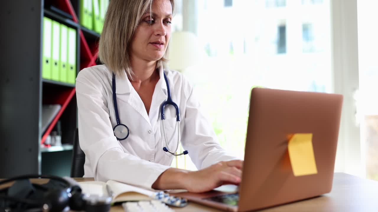 Female doctor working on a laptop in a medical office