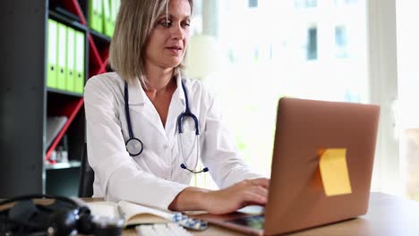 female doctor working on a laptop in a medical office