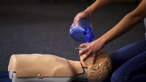 teaching procedure on a dummy. medical demonstration of resuscitation on a mannequin in training center. instructor showing breathing exercise with medical apparatus.
