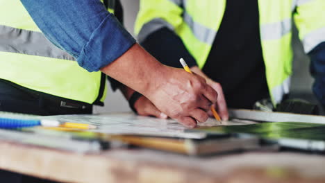 trabajadores de la construcción que revisan los planes
