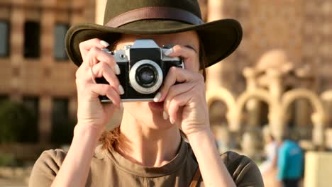 beautiful woman looks at the camera and takes a photo on the background mosque