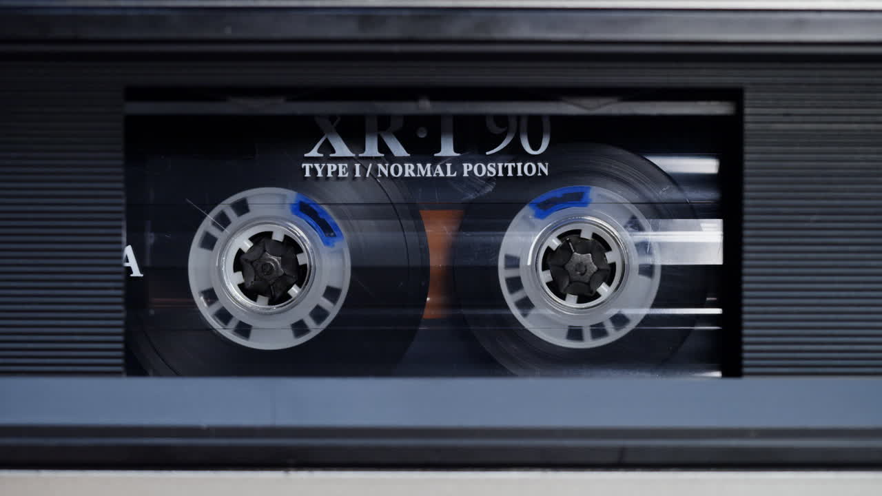 Close-up of an Audio Cassette in a Tape Deck