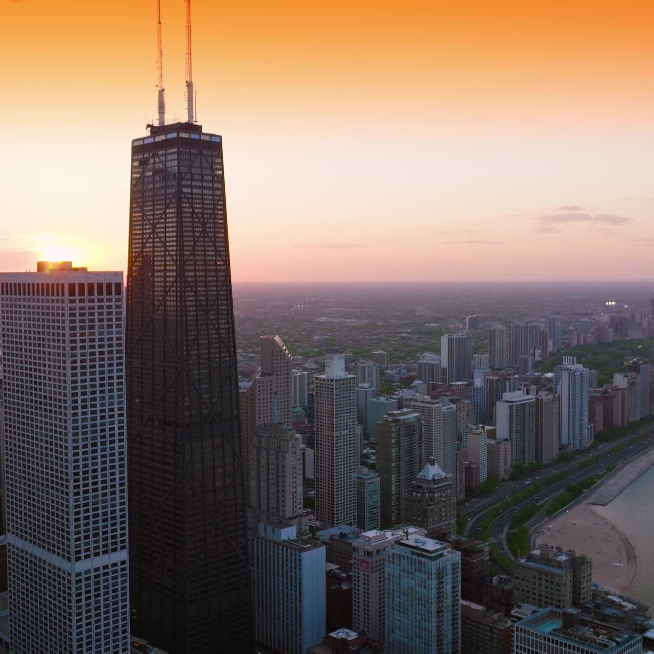 Delightful sight of amazing architecture at the waterfront of Lake Michigan. Stunning skyscrapers at Chicago downtown at the backdrop of yellow sky. Aerial view