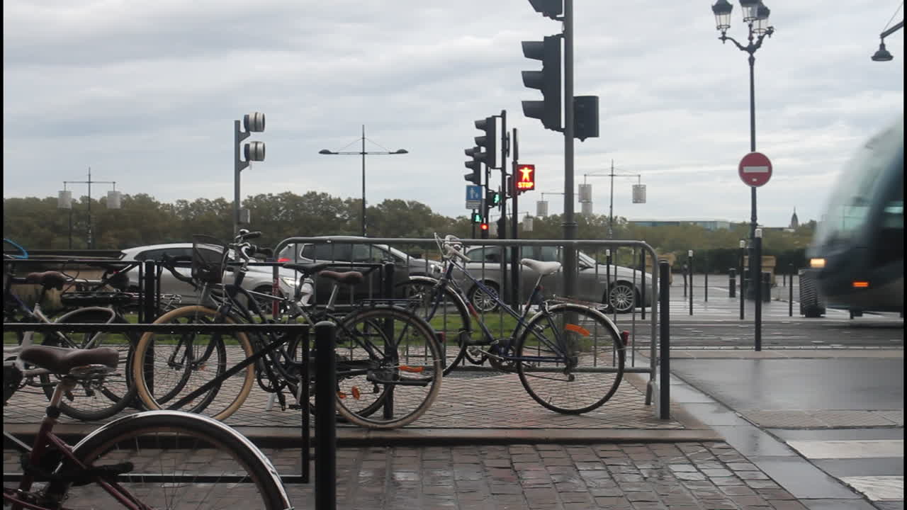 City street with bicycles and a passing tram