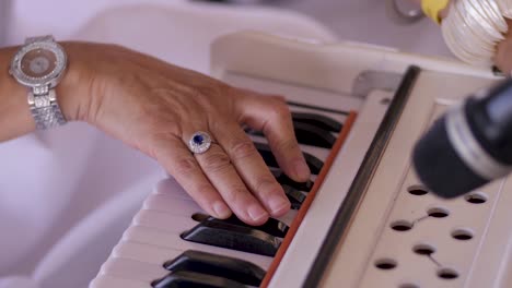 a musician playing an instrument with keys at an indian wedding