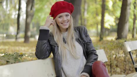 woman in beret leaning head on hand