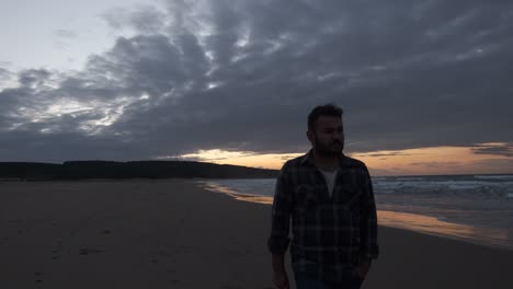 Man-Walking-Beach-at-Sunset