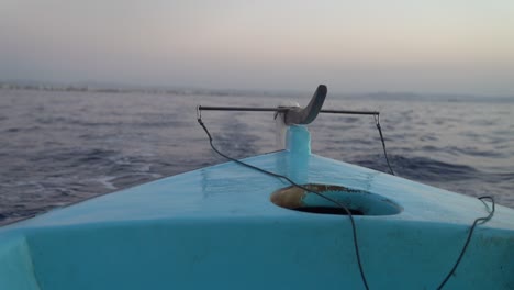 view off the back of a small fishing boat at dusk