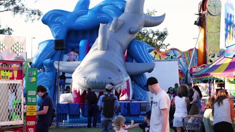 crowd enjoying a shark-themed inflatable slide