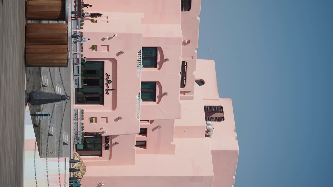 Pink Building Exterior with Outdoor Seating