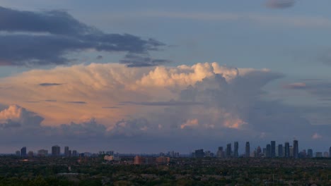 sunset time-lapse of large cumulus clouds moving above mississauga skyline