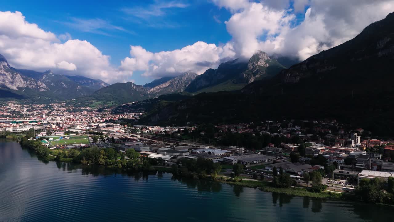 Fly backwards, view of Lecco, roads, traffic, mountains and more, Italy