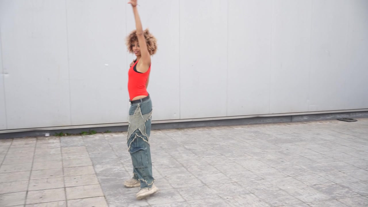 A young woman presents a dynamic urban dance performance showcasing her skills and artistry