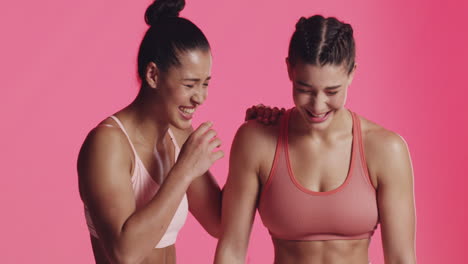 two happy women in sports bras