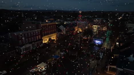 people celebrate christmas tree holiday season lights during winter snow at night