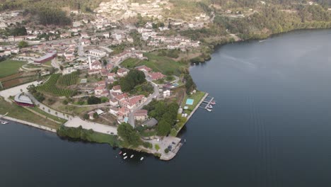 aerial top down view small village riverfront, tâmega and douro river intersection, entre-os-rios